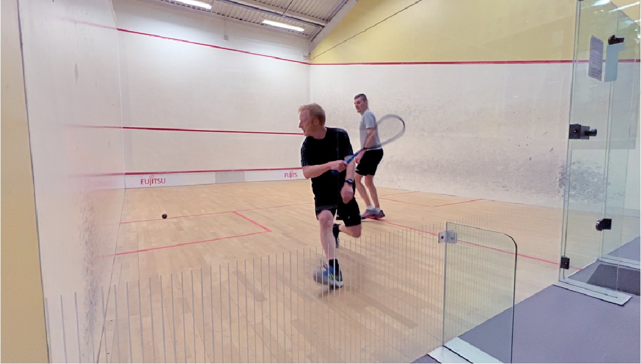 Squash player serving at Scamps Squash Club Surrey
